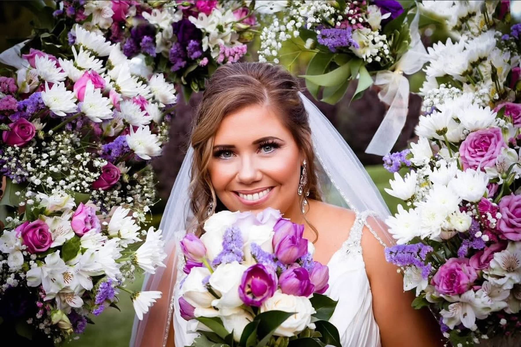 Carrie Phillips as a bride surrounded by flowers